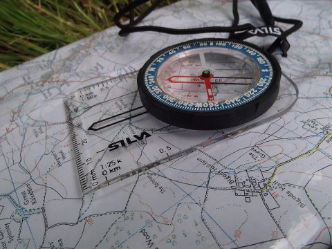 How to Actually Read a Compass A Silva baseplate orienteering compass resting on a topographic map
