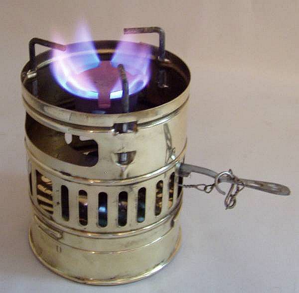 A Svea 123 stove lit with a blue flame